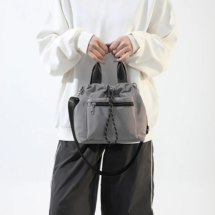 Tone Solid Gathered Bucket Carry Pouch with Dual Carry Fixtures and Front Zip Slip