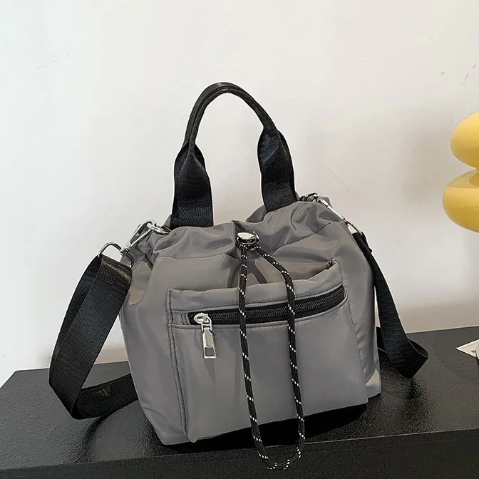 Tone Solid Gathered Bucket Carry Pouch with Dual Carry Fixtures and Front Zip Slip